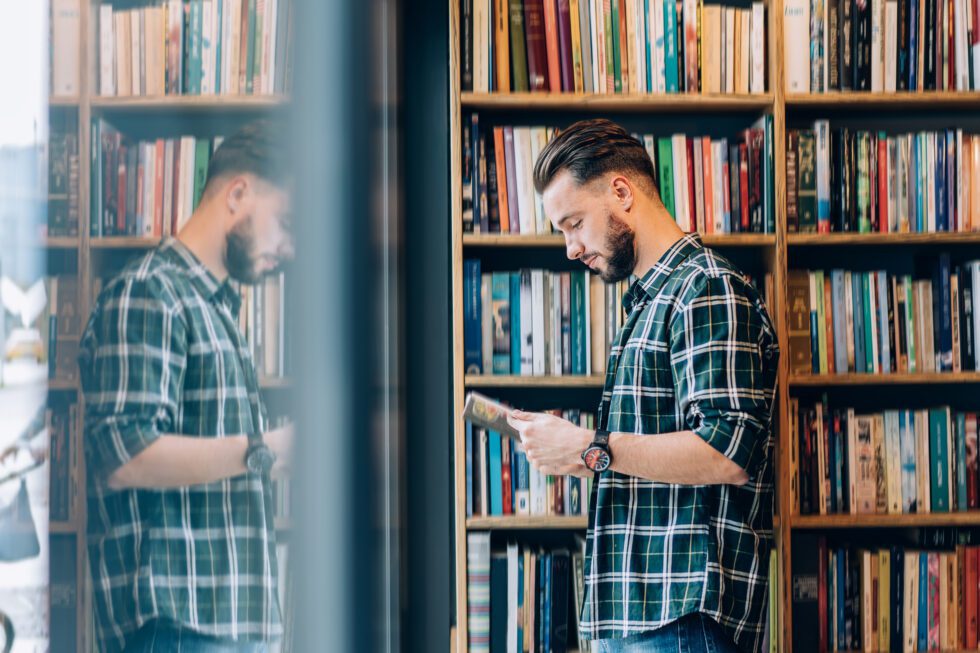 Man browsing books at a library.