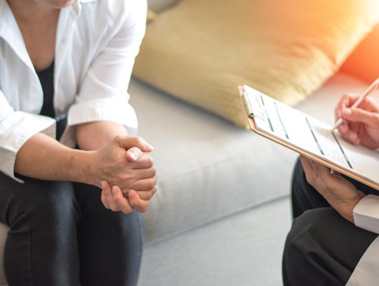 closeup - person sitting in therapy session with counselor